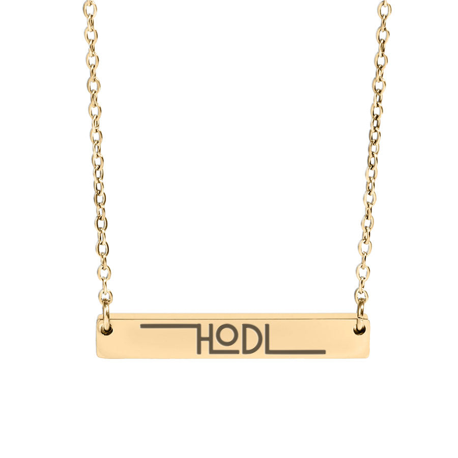 Gold necklace with a bar pendant displaying 'HODL' on a white background