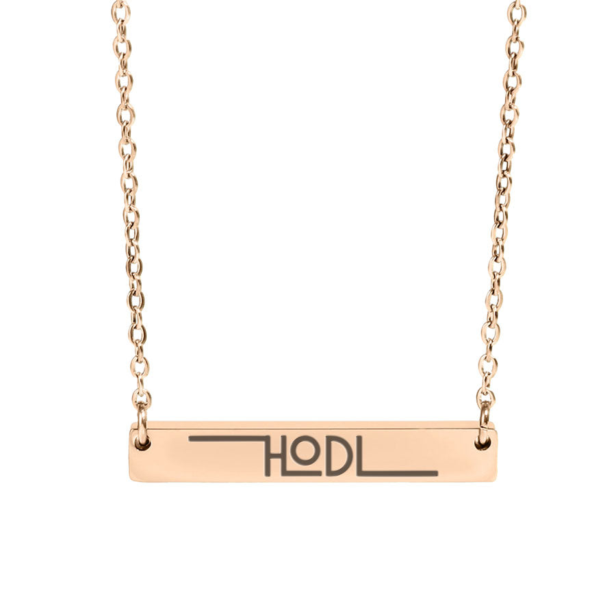 Rose gold necklace with a bar pendant displaying 'HODL' on a white background