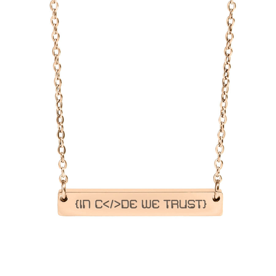 Rose gold necklace with 'IN CODE WE TRUST' engraving on a white background