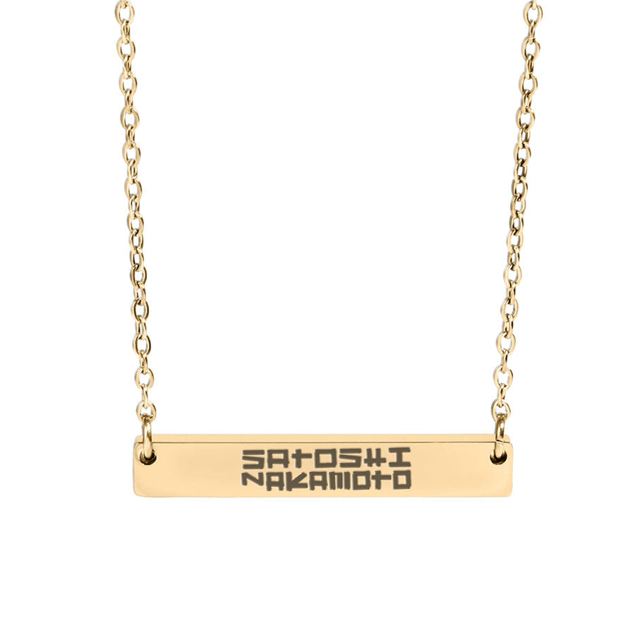 Gold necklace with a bar pendant engraved with 'Satoshi Nakamoto' on a white background