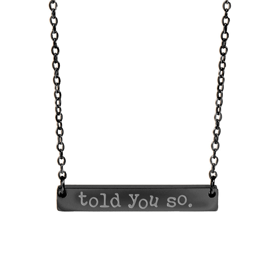 Black bar necklace with 'told you so' engraving on a white background