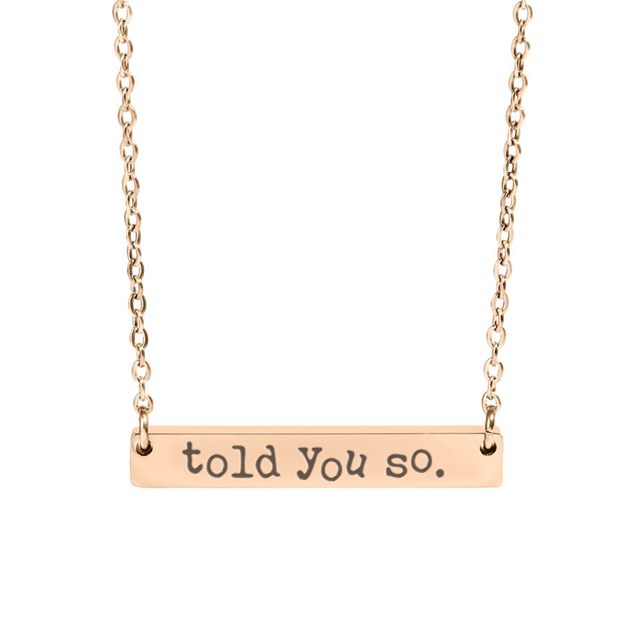 Rose gold necklace with 'told you so' pendant on a white background