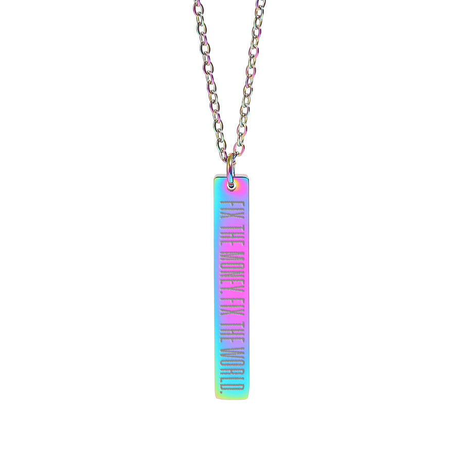 Necklace with a colorful pendant on a white background saying fix the money. fix the world.