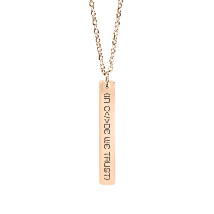Rose gold necklace with a bar pendant in code we trust on a white background