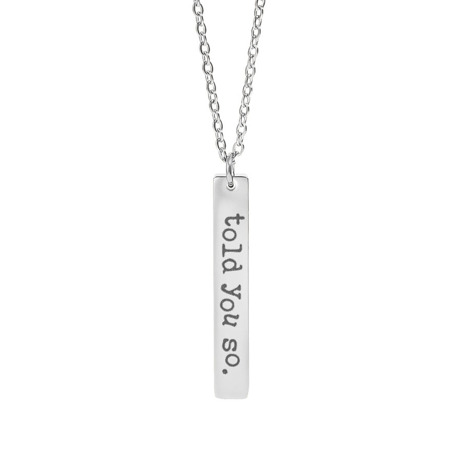 Silver necklace with a bar pendant that reads 'told you so.' on a white background