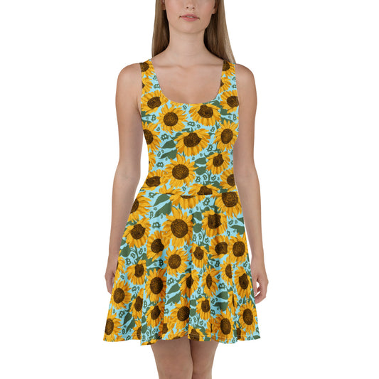 Woman wearing a sleeveless dress with sunflower and bitcoin pattern on a white background