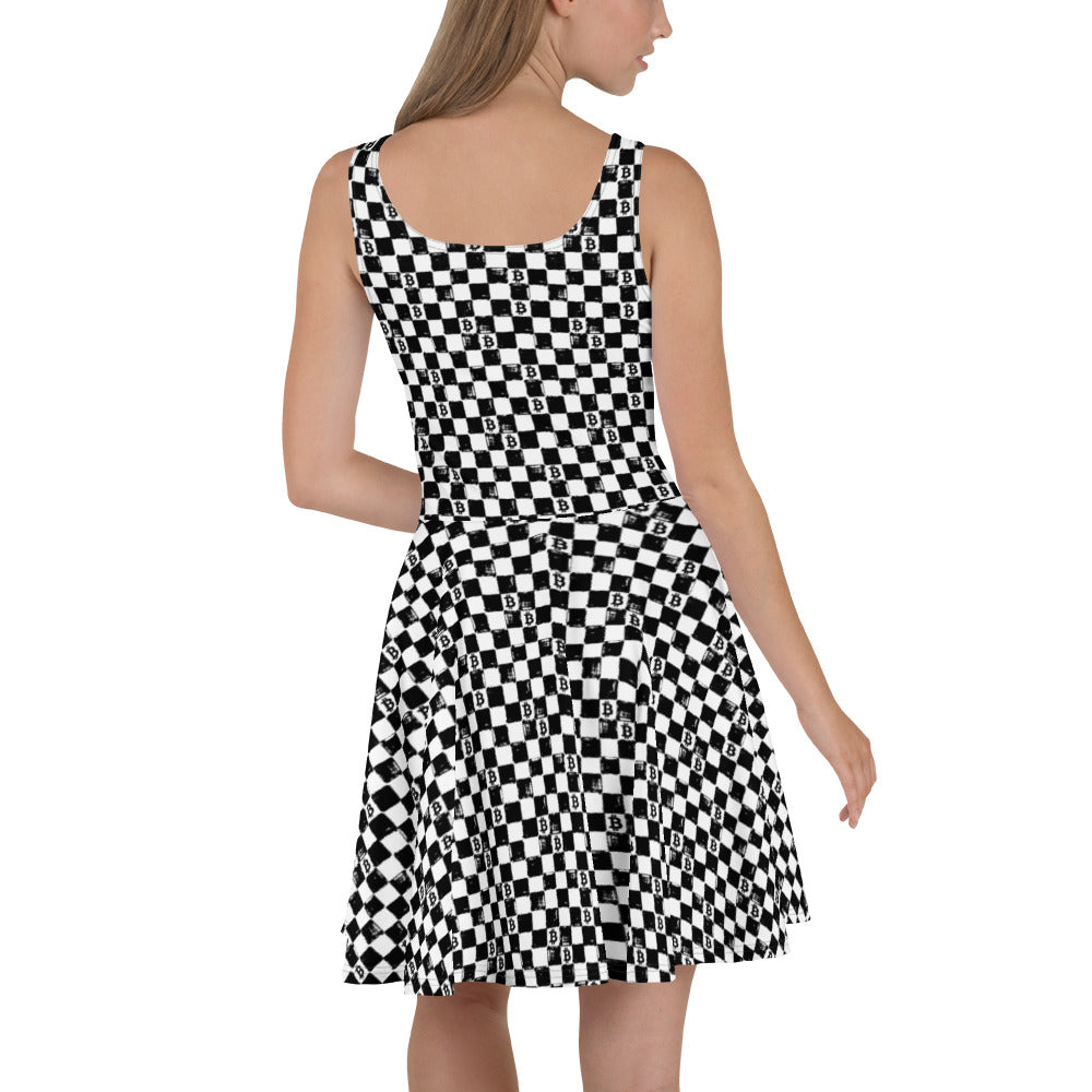 Black and white checkered bitcoin symbols dress worn by a model on a white background