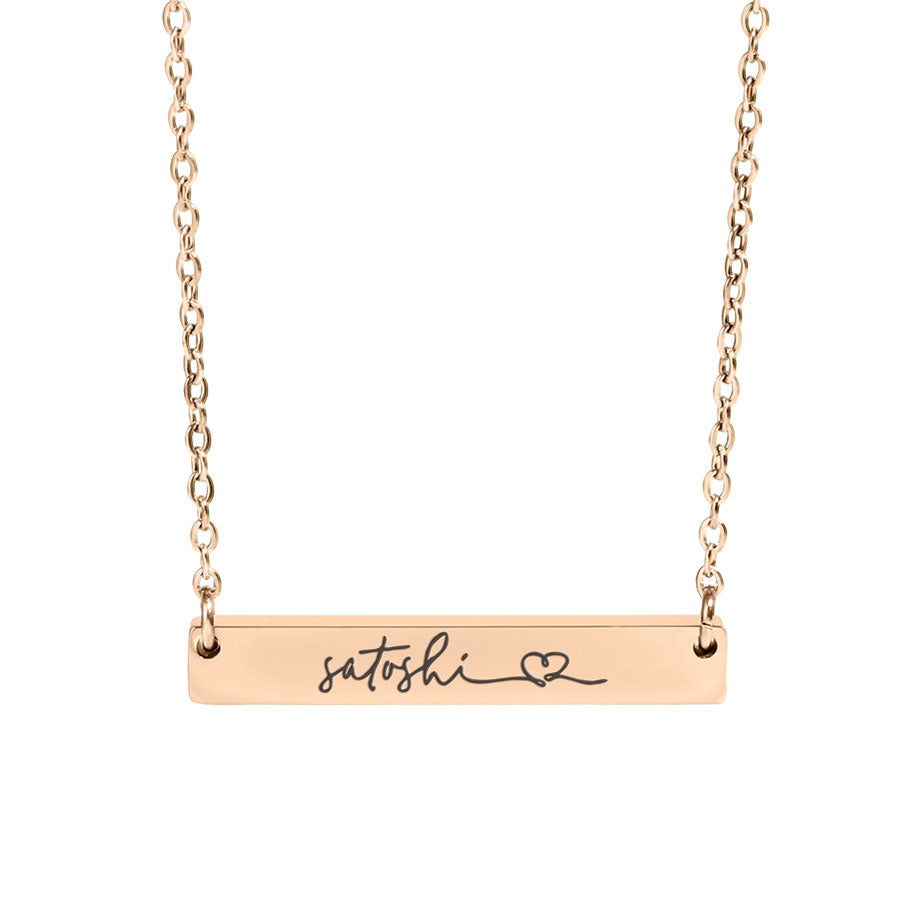 Rose gold necklace with 'satoshi' and a heart symbol on a white background
