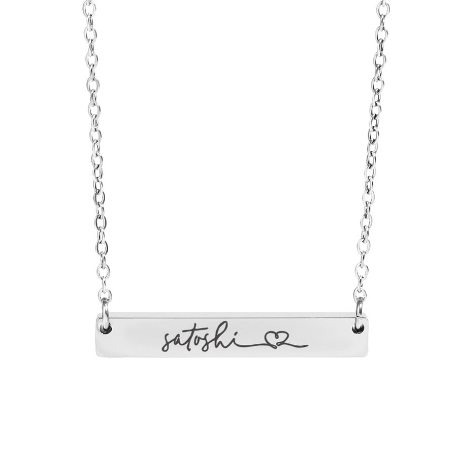 Silver necklace with a bar pendant featuring the name 'satoshi' and a heart symbol on a white background.