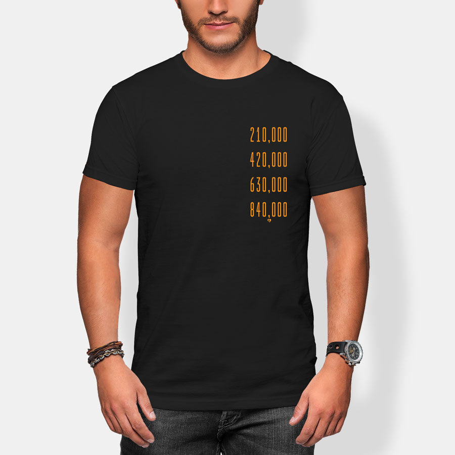 Person wearing a black t-shirt with gold halving block heights text on a white background