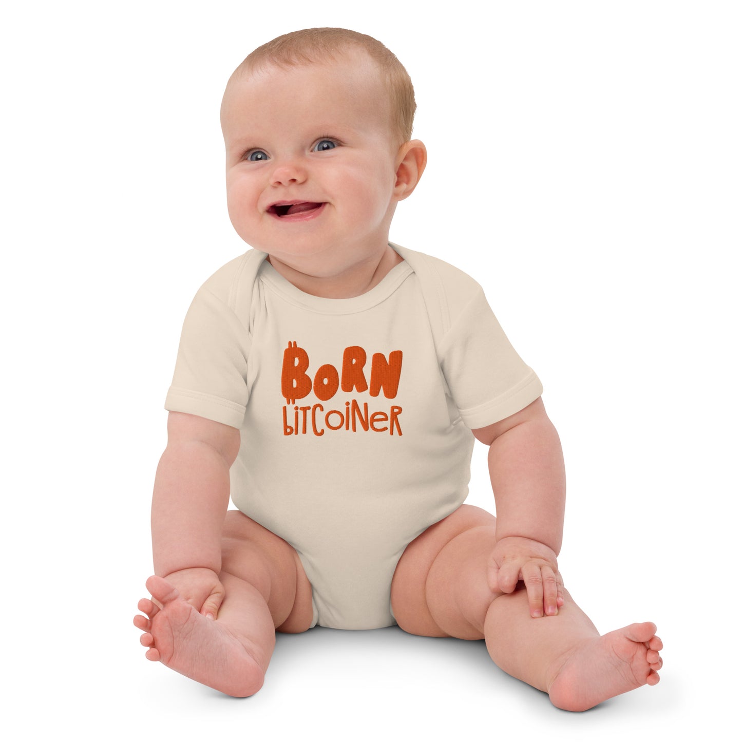 Baby wearing a onesie with 'Born Bitcoiner' text on a white background
