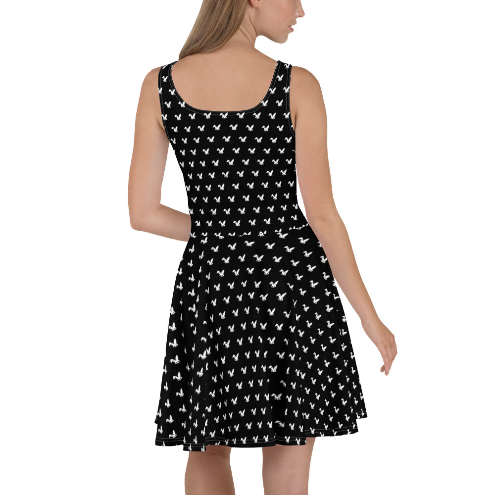 Black dress with white rabbit pattern worn by a model on a white background