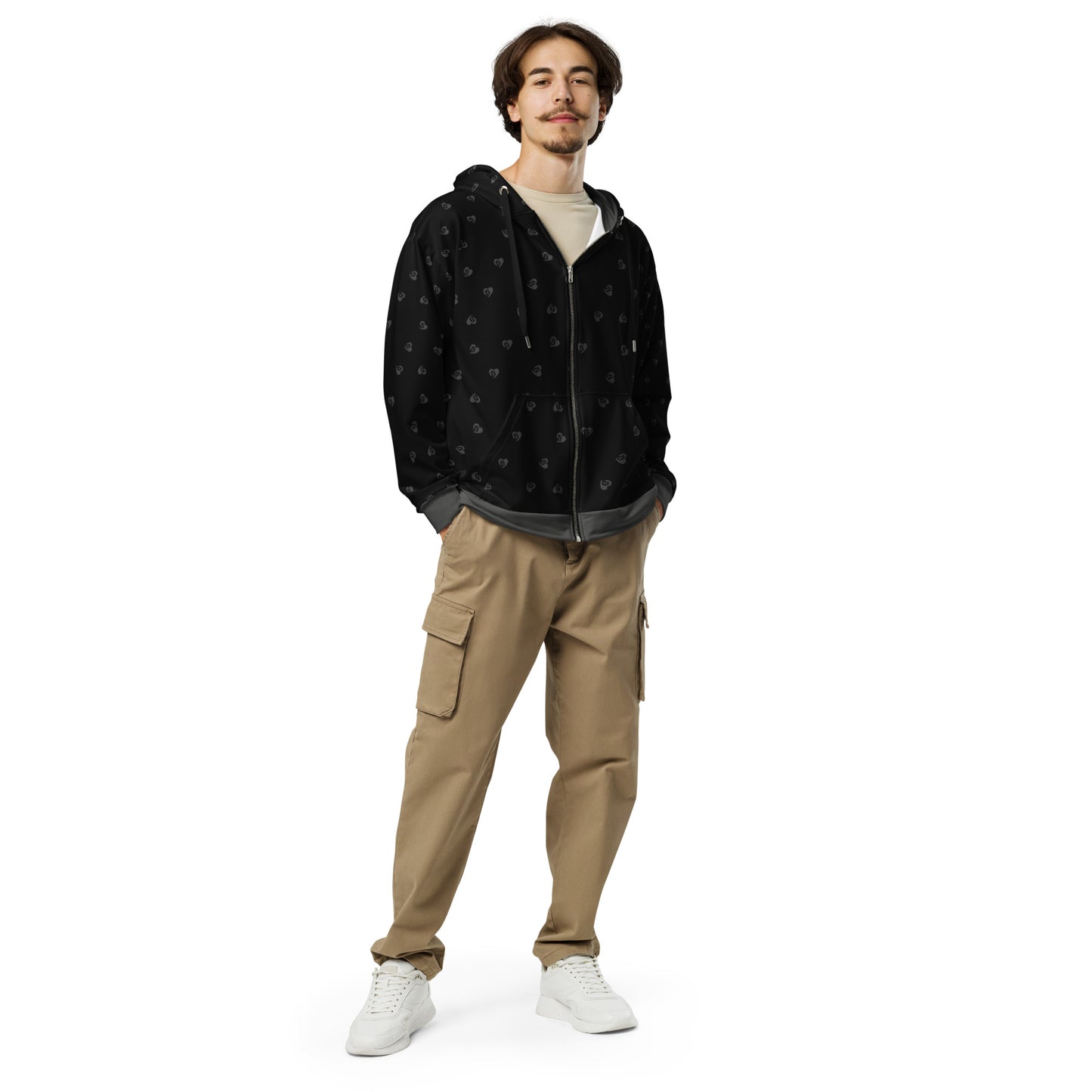 Man wearing a black bitcoin hearts patterned hoodie and beige cargo pants on a white background