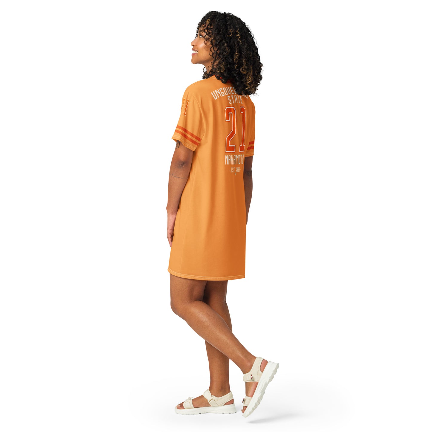 Woman wearing an orange dress with a number 21 on it against a white background