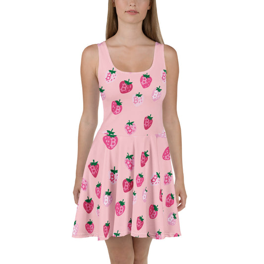 Pink dress with strawberry bitcoin pattern worn by a model on a white background
