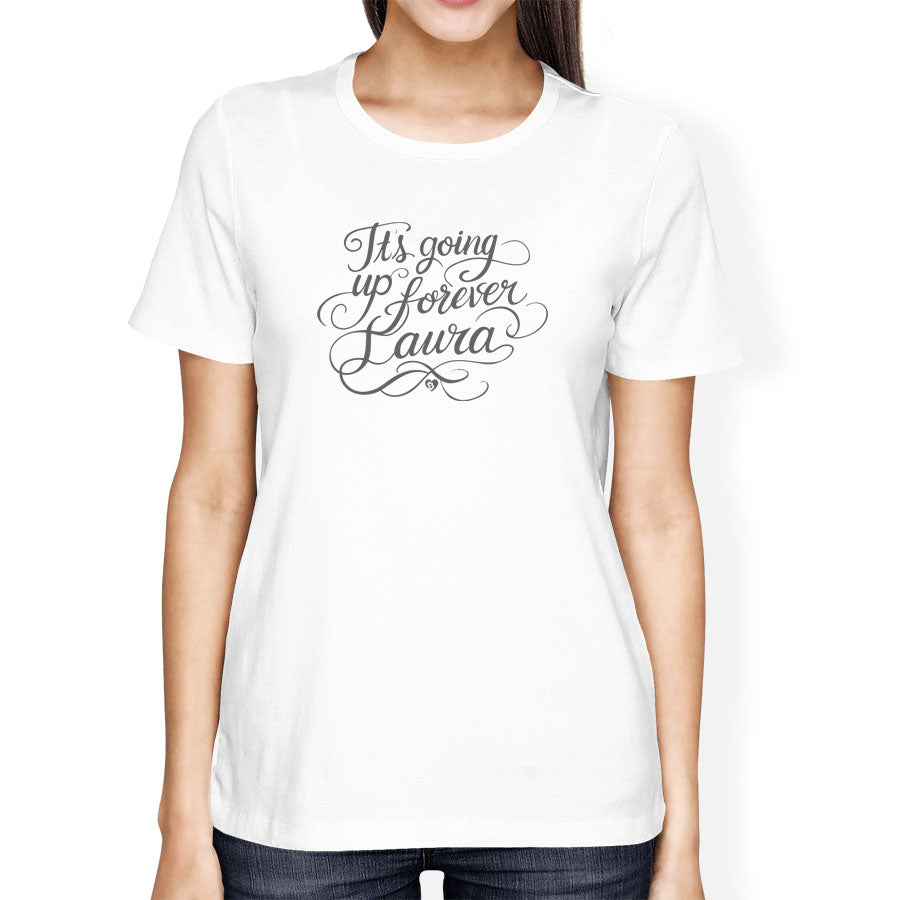 White t-shirt with text 'It's going up forever Laura' worn by a person on a white background