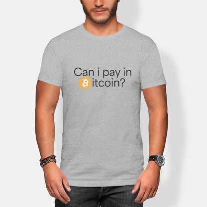 Person wearing a gray t-shirt with Bitcoin-themed can I pay in bitcoin text on a plain background