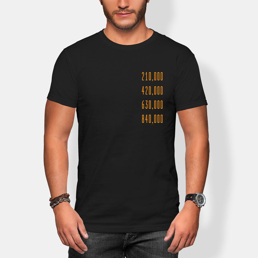 Person wearing a black t-shirt with gold halving block height numbers text on a white background