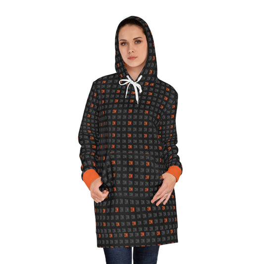 Woman wearing a black and orange 21 million patterned hooded coat on a white background