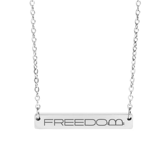 Silver necklace with 'FREEDOM' bar pendant on a white background