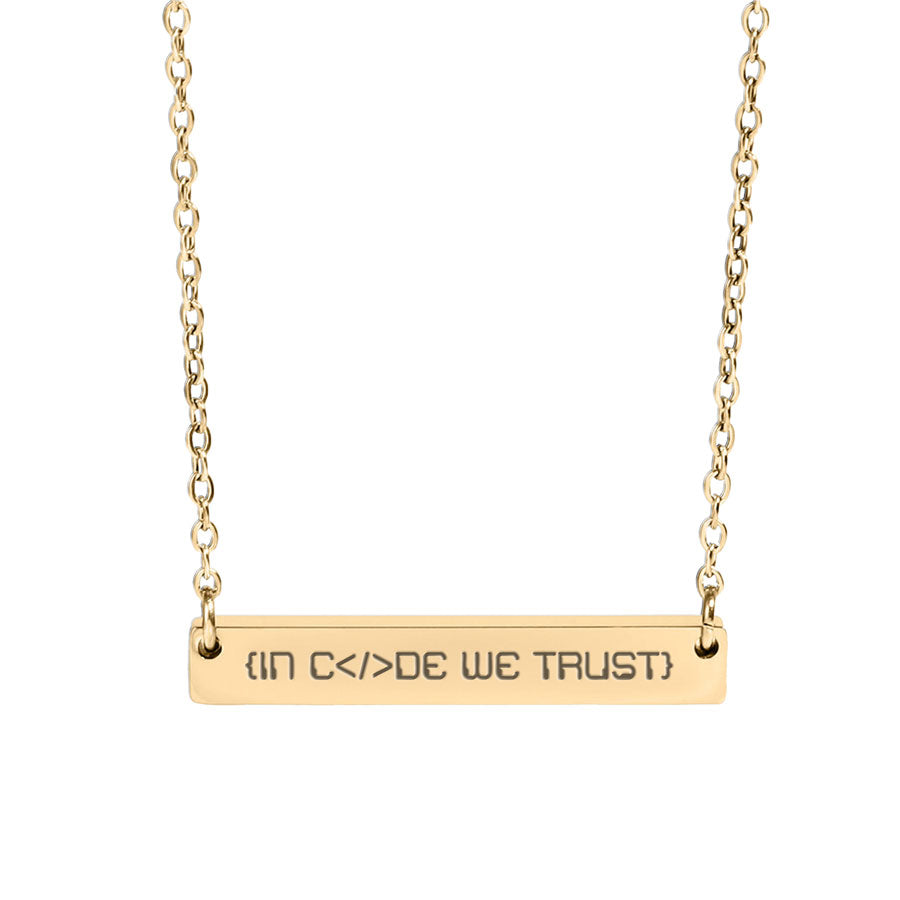 Gold necklace with 'IN Code WE TRUST' engraving on a white background