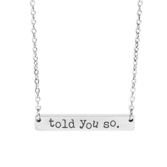Silver necklace with 'told you so' pendant on a white background