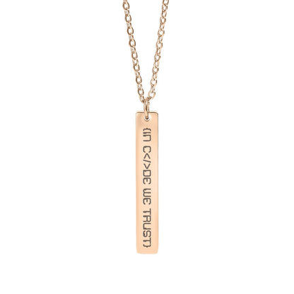 Rose gold necklace with a bar pendant in code we trust on a white background