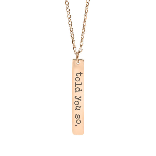 Rose gold necklace with a bar pendant engraved 'told you so.' on a white background