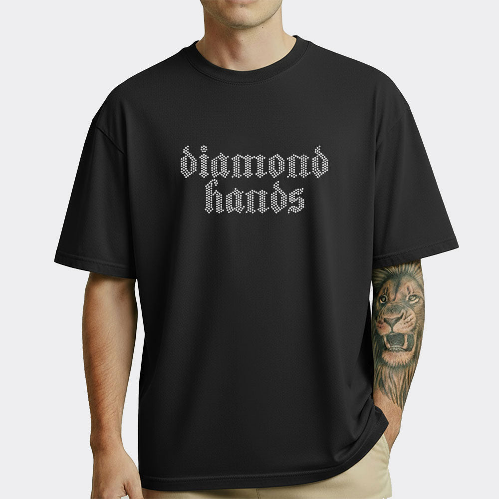 Black t-shirt with 'diamond hands' text worn by a person on a white background