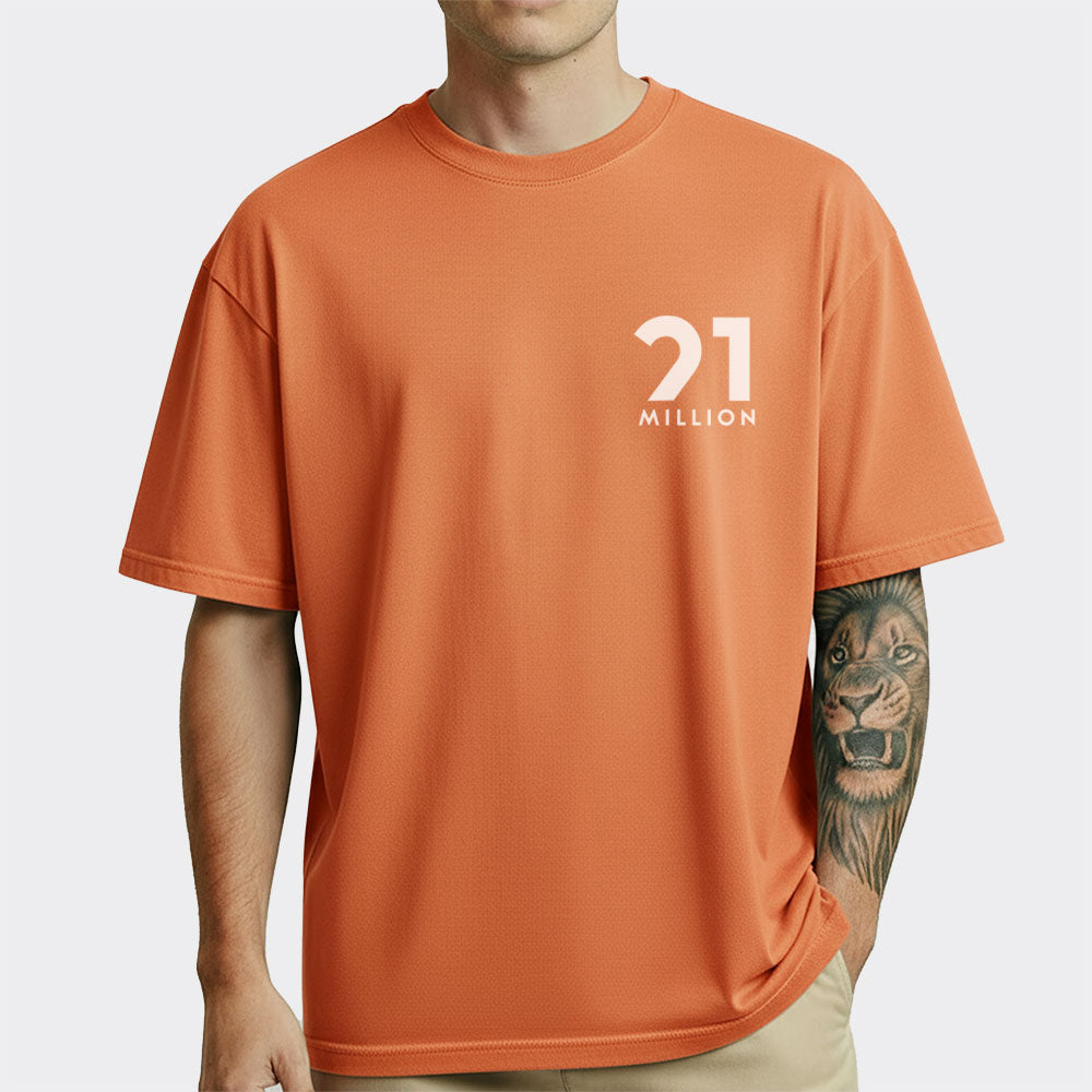 Person wearing an orange t-shirt with '21 Million' logo on a white background