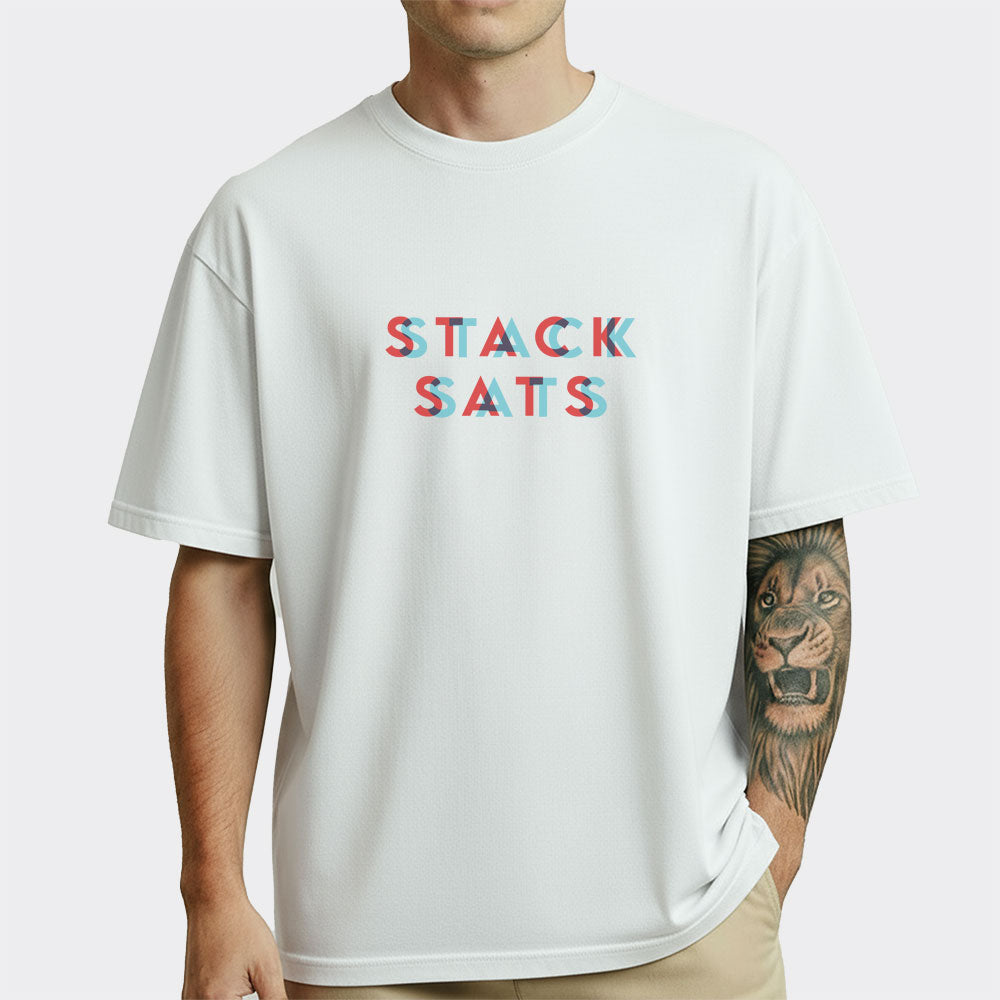 Person wearing a white t-shirt with colorful stack sats text design on a plain background