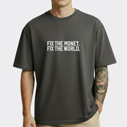 Person wearing a black t-shirt with 'FIX THE MONEY. FIX THE WORLD.' text on a white background