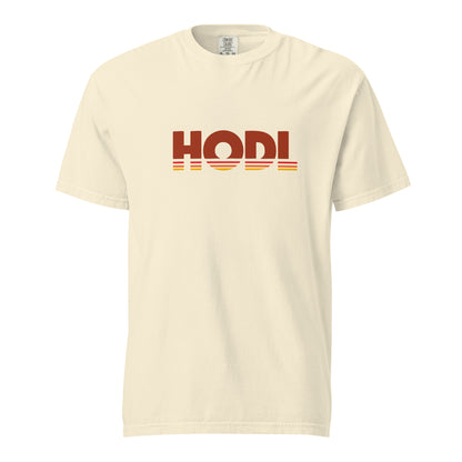Beige t-shirt with 'HODL' printed on it against a white background