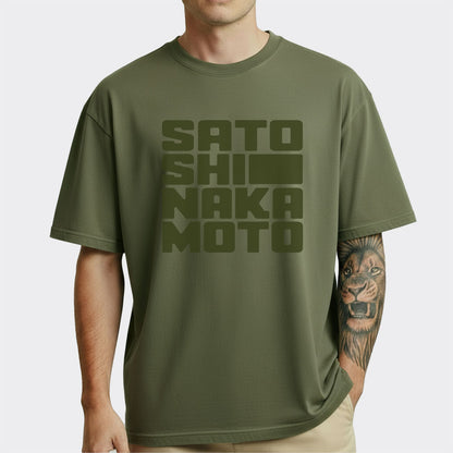 Person wearing a green t-shirt with 'SATOSHI NAKAMOTO' text on a white background