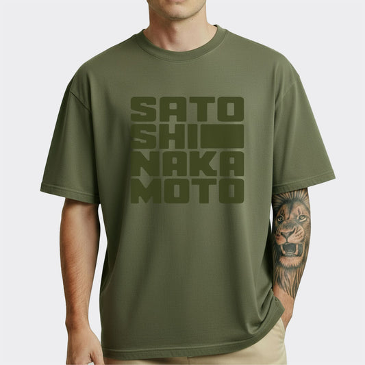 Person wearing a green t-shirt with 'SATOSHI NAKAMOTO' text on a white background