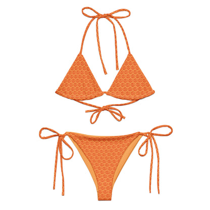 Orange bikini set with geometric orange bitcoin pattern on a white background