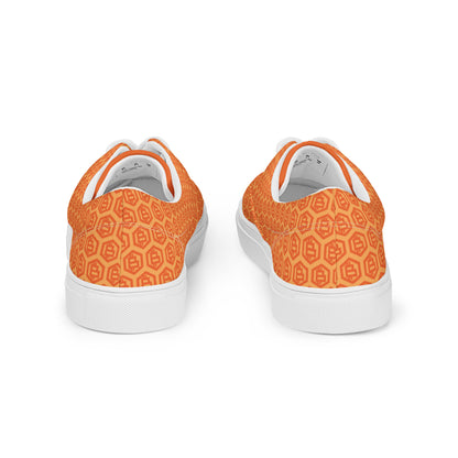 Orange patterned sneakers with white soles on a white background