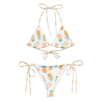 Two-piece bikini set with pineapple bitcoin pattern on a white background