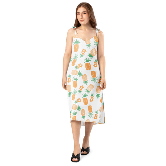 Woman wearing a sleeveless dress with pineapple bitcoin pattern on a white background
