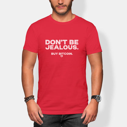 Red t-shirt with 'DON'T BE JEALOUS. BUY BITCOIN.' text worn by a person on a white background