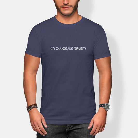 Man wearing a navy blue t-shirt with in code we trust white text on a plain background