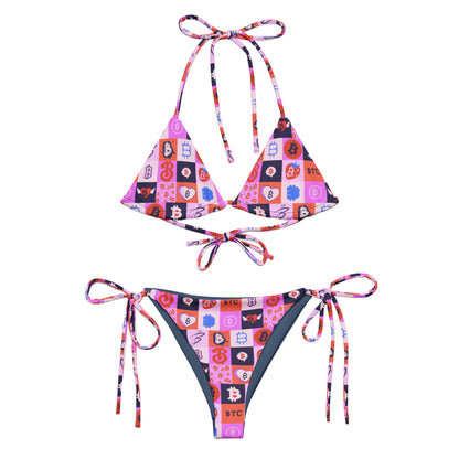 Colorful bitcoin bikini set with geometric pattern on a white background