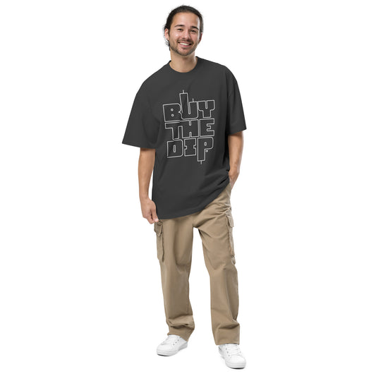 Man wearing a black t-shirt with 'BUY THE DIP' text and beige pants on a white background
