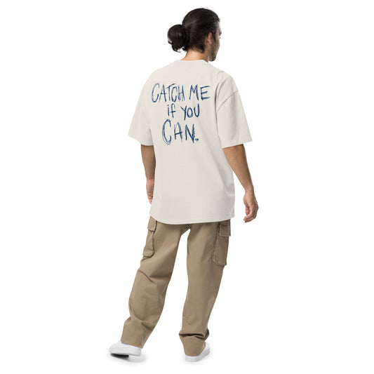 Person wearing a white t-shirt with catch me if you can text on the back, standing against a white background