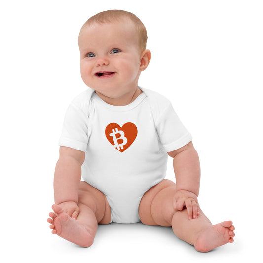 Baby wearing a white onesie with a red heart-shaped Bitcoin logo on a white background