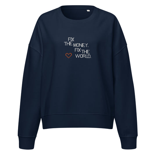 Navy blue sweatshirt with fix the money. fix the world. text and heart design on a white background
