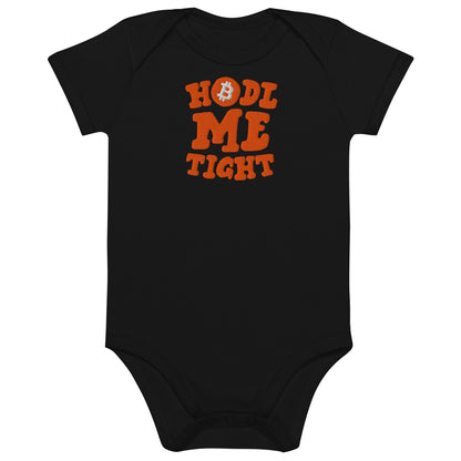 Black baby onesie with orange text 'HODL ME TIGHT' on a white background