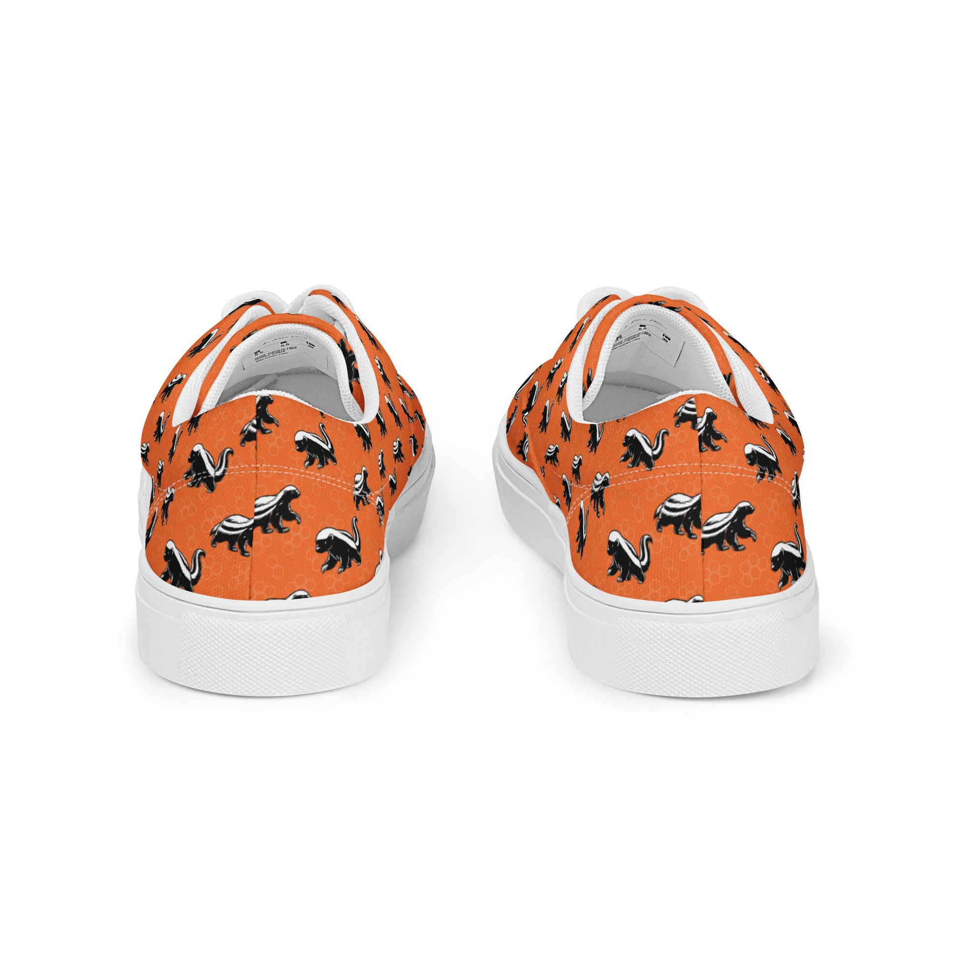 Orange sneakers with black animal pattern on a white background