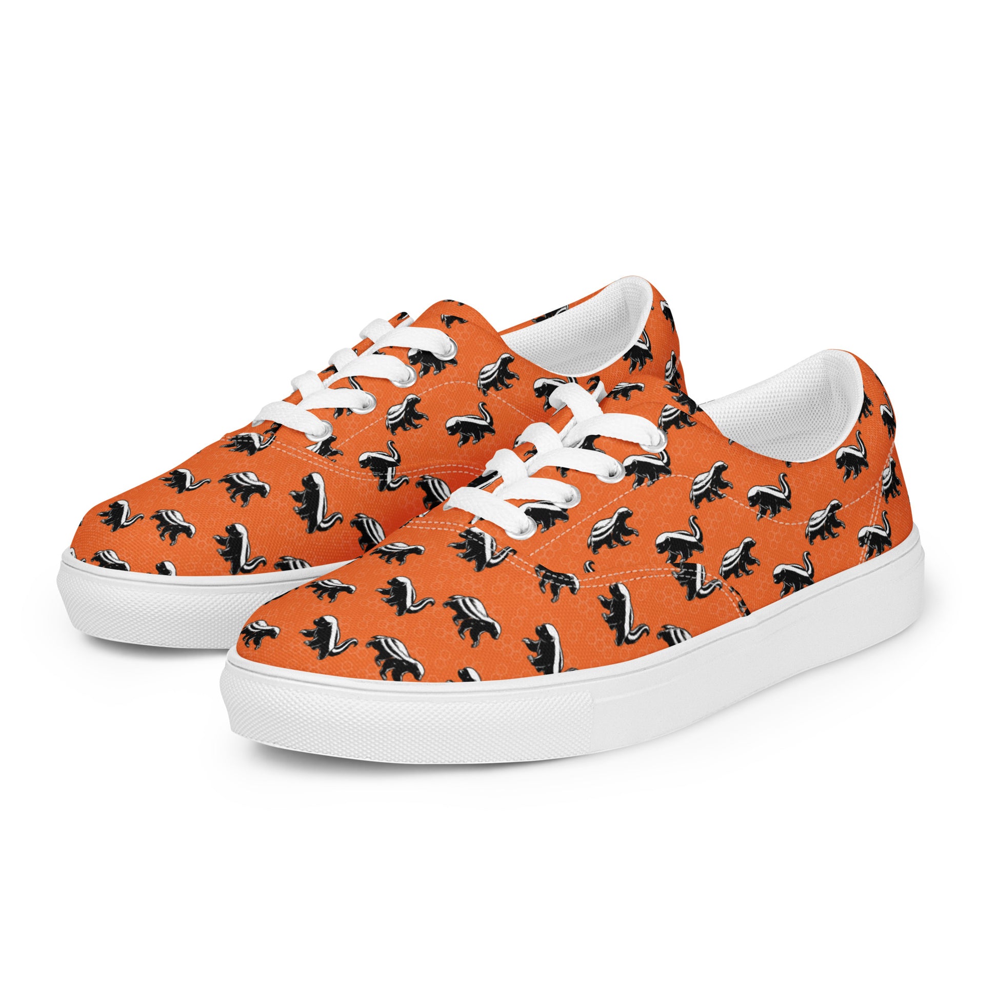 Orange sneakers with honey badger black and white pattern on a white background