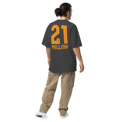 Person wearing a dark gray t-shirt with '21 MILLION' printed on the back, standing against a white background.